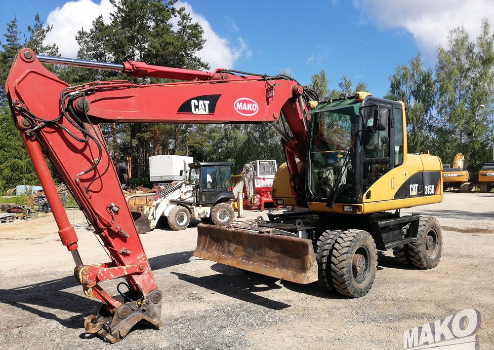 Caterpillar M315 C - Pelle sur pneus: photos 1 Caterpillar M315 C - Pelle sur pneus: photos 1
