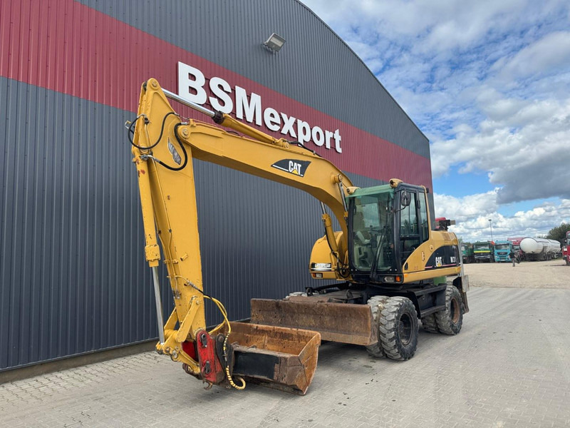 Caterpillar M 315 C - Pelle sur pneus: photos 1 Caterpillar M 315 C - Pelle sur pneus: photos 1