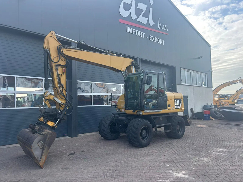 Caterpillar M313D - Pelle sur pneus: photos 1 Caterpillar M313D - Pelle sur pneus: photos 1