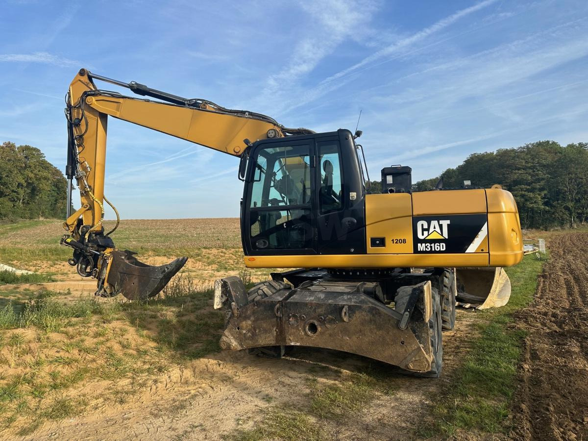 Caterpillar M 316D - Pelle sur pneus: photos 1 Caterpillar M 316D - Pelle sur pneus: photos 1